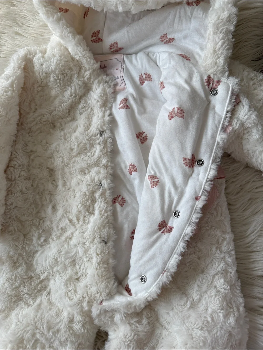 Plush Cream Hooded Baby Onesie with Pink Ribbon Closures